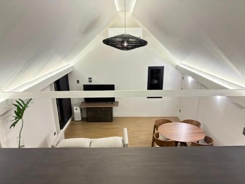 a room with a table and chairs in a room at Elev Ph - Staycation Penthouse in San Nicolas