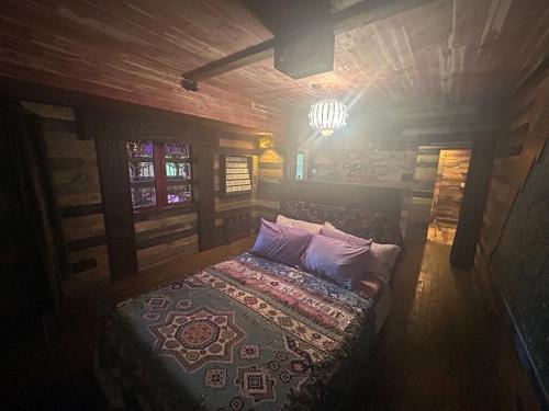 a bedroom with a bed in a wooden room at Luminary Lodge in Sevierville