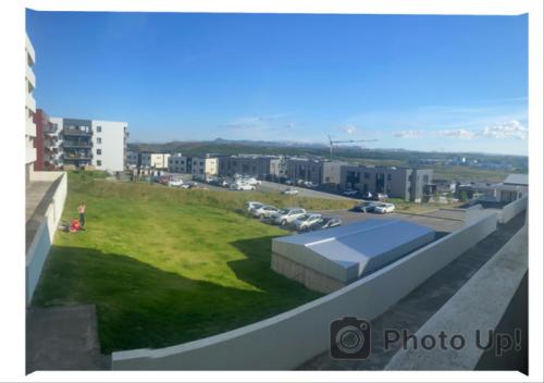 a view of a field of grass on top of a building at Friggjarbrunnur shared home in Reykjavík