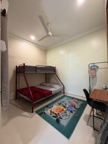 a bedroom with a bunk bed and a rug at Teratak Bonda in Temuh