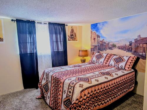 a bedroom with a bed with a painting on the wall at By State Fair 5 bedrooms 2 baths in Des Moines