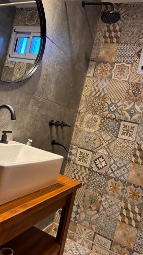 a bathroom with a sink and a mirror at Duplex Playa Mansa in Mina Clavero