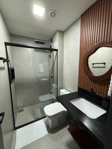 a bathroom with a shower and a toilet and a sink at Flat Praia da Graciosa in Palmas
