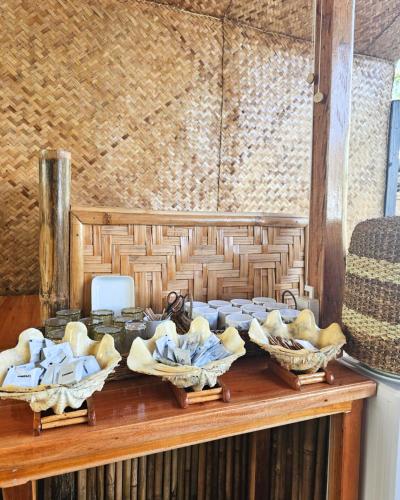 a table with baskets of towels on top of it at Trisha Guesthouse in San Vicente
