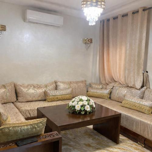 a living room with a couch and a table at Prime stay downtown Meknes in Meknès