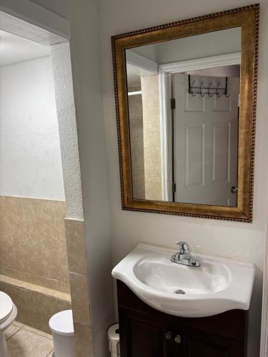 a bathroom with a sink and a mirror and a toilet at Beach getaway - Private paradise - Clearwater in Clearwater