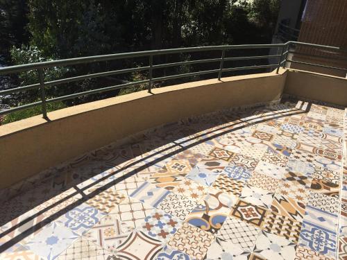 a mosaic floor on a balcony with a railing at Apartment Cau Cau in Horcón