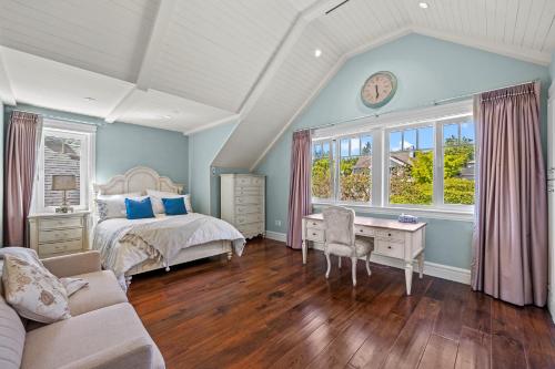 a bedroom with a bed and a desk at Spacious Cozy House in Vancouver West in Vancouver