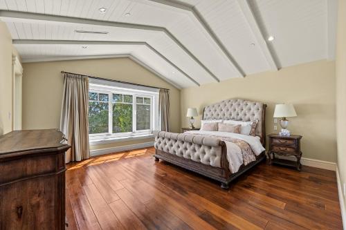 a bedroom with a large bed and a large window at Spacious Cozy House in Vancouver West in Vancouver
