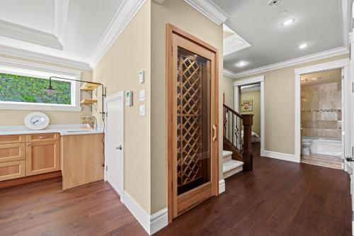 a kitchen with a door leading to a bathroom at Spacious Cozy House in Vancouver West in Vancouver