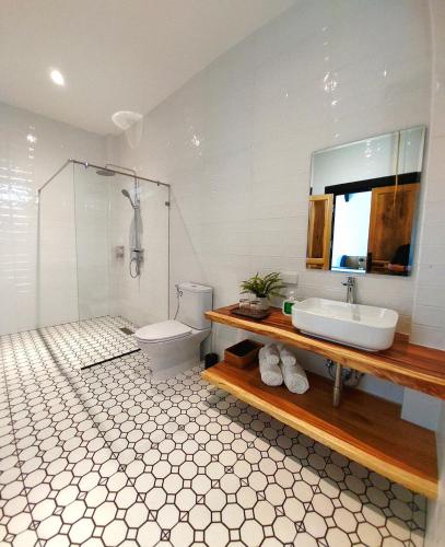 a bathroom with a sink and a toilet and a mirror at Ing Suan pool villa 1 in Ao Nang Beach