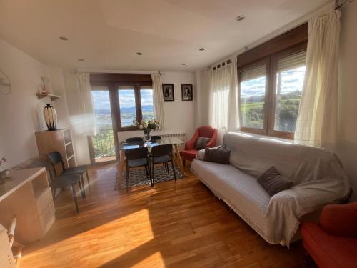 a living room with a couch and a table at Apartamentos Casa Carmen in Suances