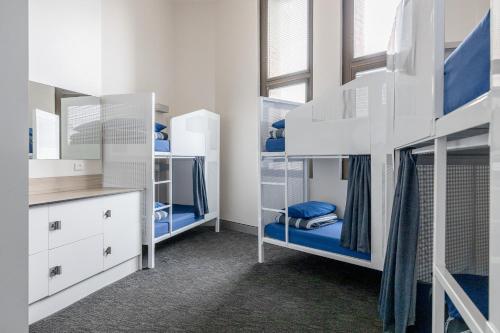 a room with two bunk beds and a mirror at Wake Up! Sydney Central in Sydney