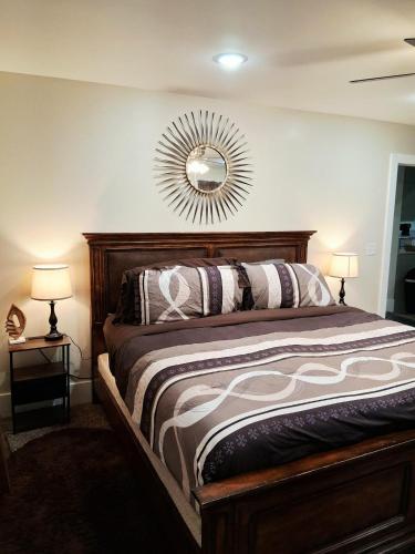 a bedroom with a bed with a mirror on the wall at Xscapecatio Oasis II in Tulsa