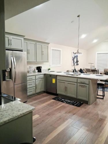 a kitchen with stainless steel appliances and wooden floors at Xscapecatio Oasis II in Tulsa