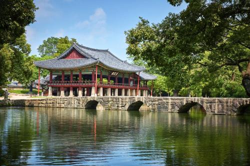 a building on a bridge over a body of water at KensingtonResort JirisanNamwon in Namwon