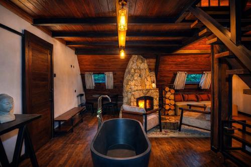 a bathroom with a tub and a stone fireplace at Kubana in Nuwara Eliya