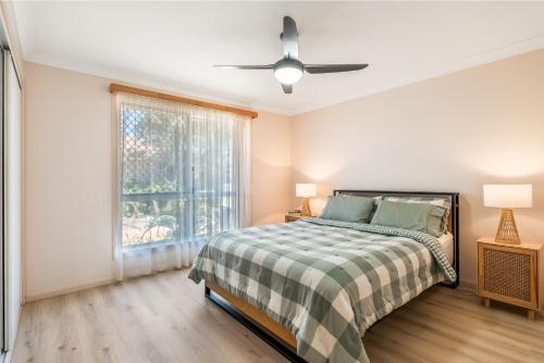 a bedroom with a bed and a window at Waratah Retreat in Evans Head