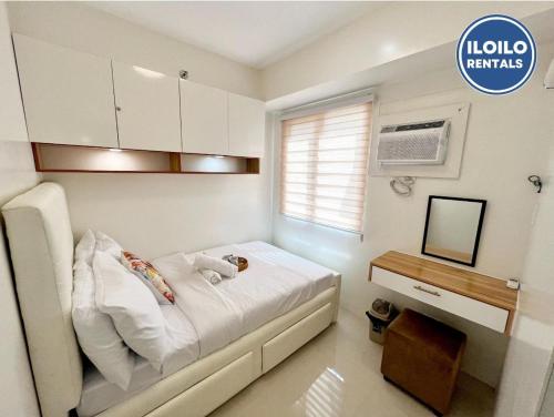 a small bedroom with a bed and a television at Modern Style 2-BR in SMDC in Iloilo City