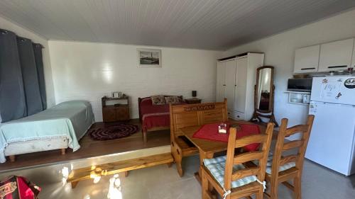 a small kitchen with a table and a refrigerator at Monoambiente 4 blocks away from the beach! in Paysandú