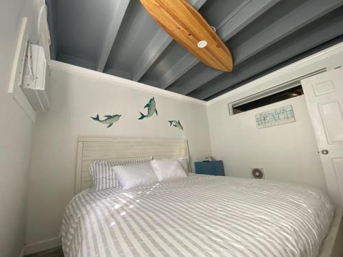 a bedroom with a bed and a wooden ceiling at Tiny home living!! First floor condo! in Panama City Beach