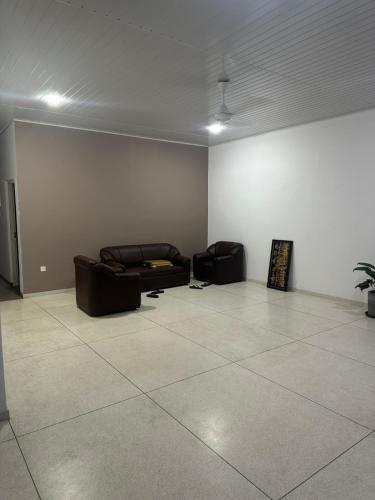 a living room with two couches in a room at Solace More Hotel - Borella 2 in Colombo