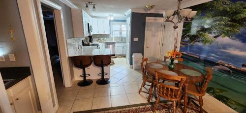 a kitchen and dining room with a table and chairs at Unique 2 Bedroom / 2 Bath Condo in Myrtle Beach in Myrtle Beach