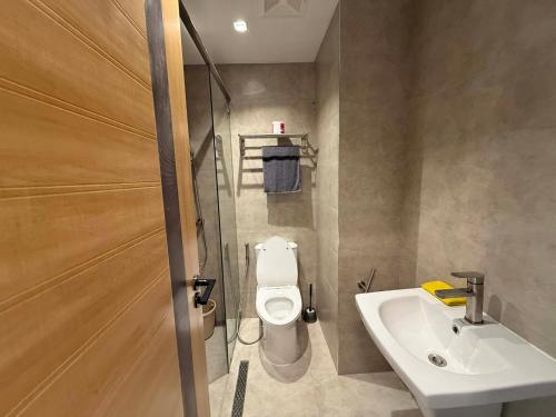 a bathroom with a toilet and a sink at Wide studio Antara Residences Talisay in Talisay