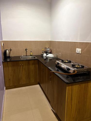 a kitchen with a stove and a sink at Zarica Homestay in Kannur