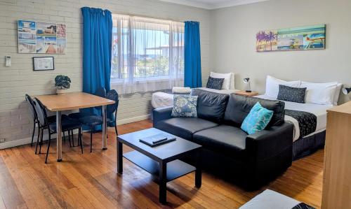 a living room with a couch and a bed at Ocean Drive Motel in Bunbury