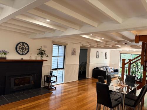 a living room with a fireplace and a table at Bonza Family Retreat in Kalorama