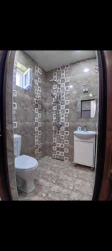 a bathroom with a toilet and a sink at Tom House Garden in Tsaghkadzor