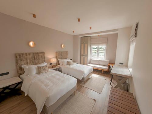 a large bedroom with two beds and a window at Stone Heaven Villa in Nuwara Eliya