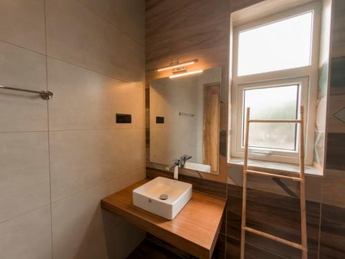 a bathroom with a sink and a mirror at Stone Heaven Villa in Nuwara Eliya