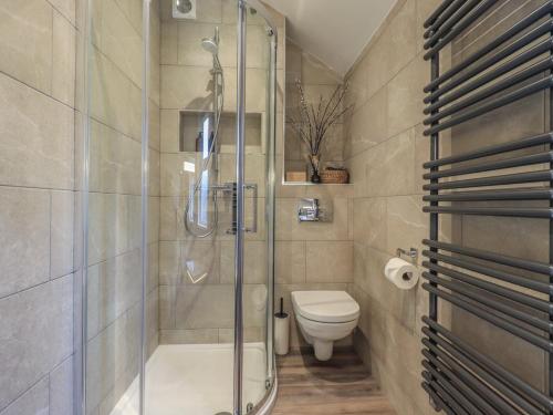 a bathroom with a shower and a toilet at West View in Milnthorpe