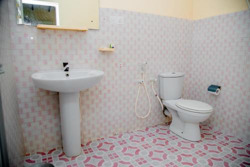a bathroom with a sink and a toilet at Lavendish Country Resort in Dambulla