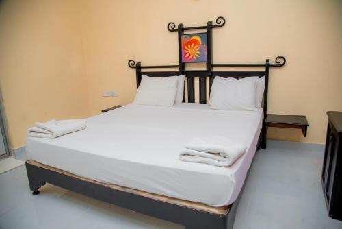 a large bed with towels on it in a room at Lavendish Country Resort in Dambulla