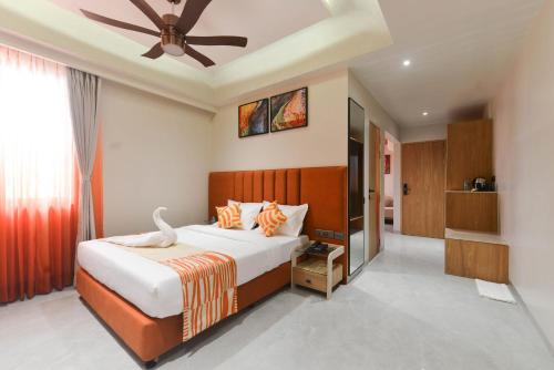 a bedroom with a bed and a ceiling fan at Bhagwati luxuria in Indore