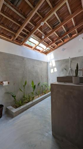 a room with a row of plants on the wall at Inara Stay in Arugam Bay