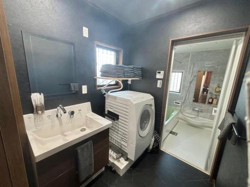 a bathroom with a sink and a shower at HOTTOSTAY OoGANE in Nagoya