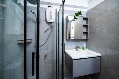a bathroom with a shower and a sink at Shangri LA Residency in Gatunga