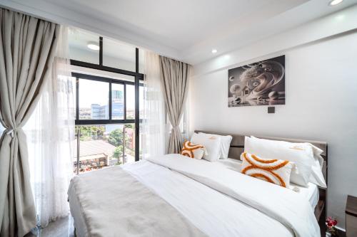 a bedroom with a large bed and a window at Shangri LA Residency in Gatunga