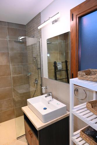 a bathroom with a sink and a shower at Wateera Jebel Sifah-Beachfront & Golf View in As Sīfah