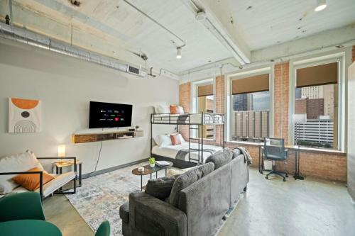 a living room with two couches and a tv at Beautiful Downtown Apartment with Pool, Laundry, Parking in Dallas