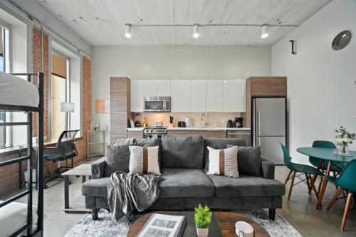 a living room with a couch and a table at Beautiful Downtown Apartment with Pool, Laundry, Parking in Dallas