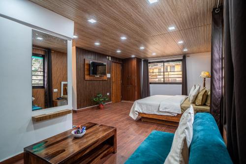 a bedroom with a bed and a couch at Peaks n Pines in Nainital