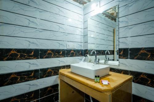 a bathroom with a sink and a mirror at Desert Story Night Camp in Jaisalmer