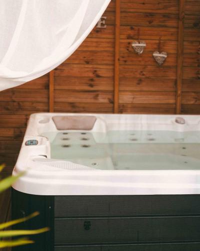 a jacuzzi tub in a room with wood at Chambre d'hôte La Kazanou in Saint-Joseph