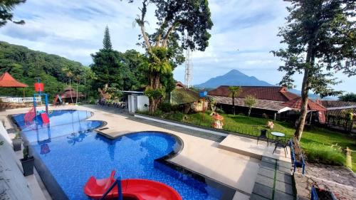 a pool at a resort with a playground at Inna Tretes Hotel & Resort in Prigen