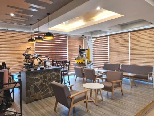 a restaurant with tables and chairs and a fireplace at Star Hotel Davao in Davao City
